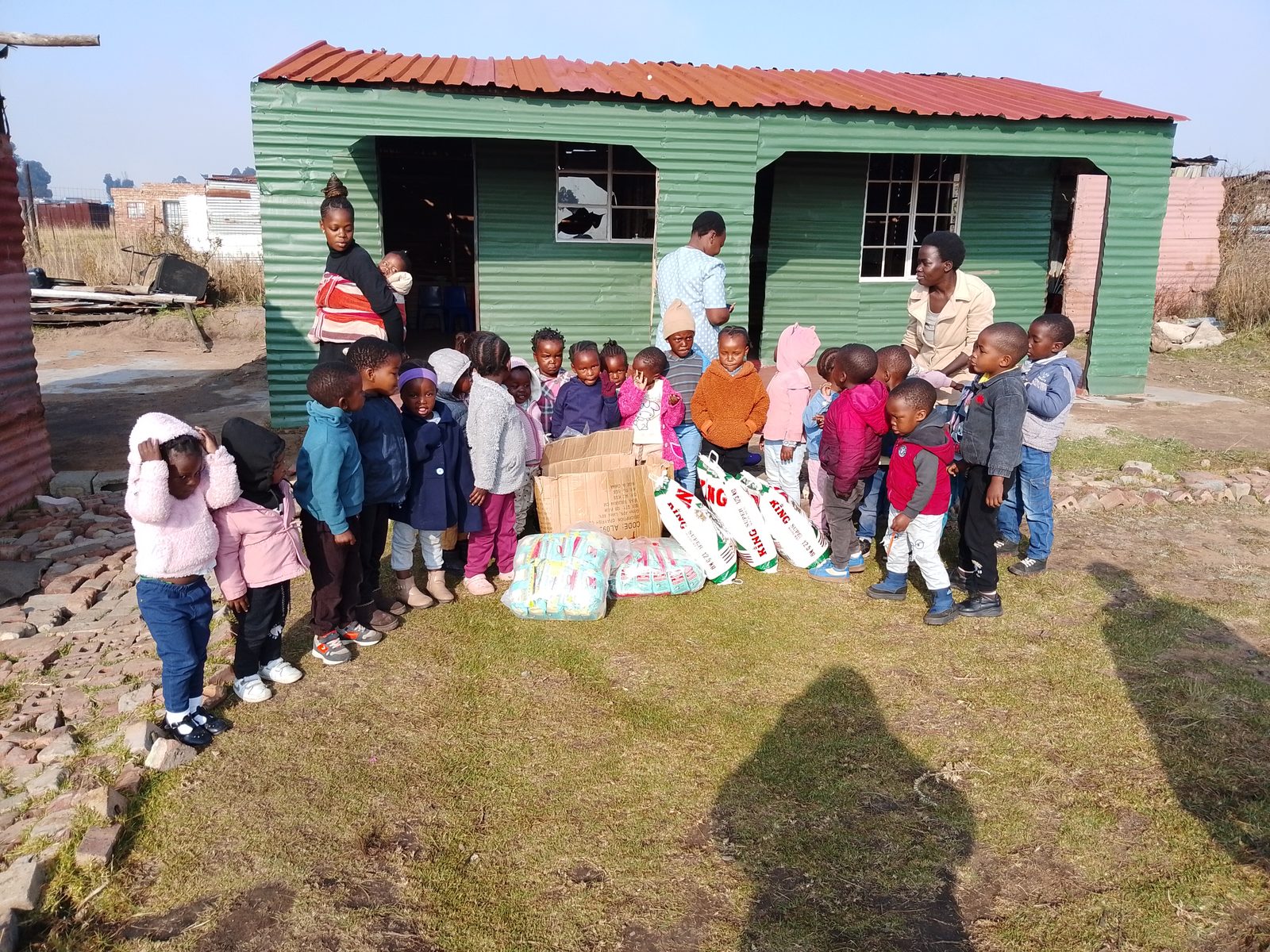 Children and carers outside a community early-learning centre in Mpumalanga